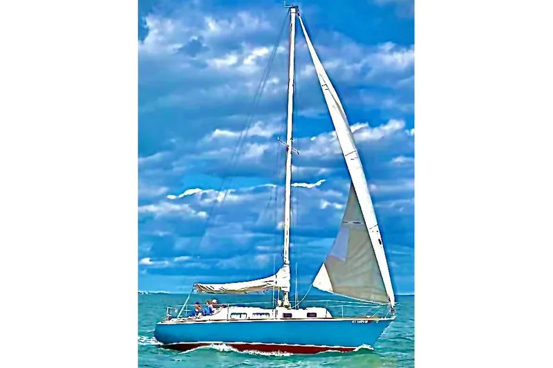 Slide: The Image of 1974 Tartan Sloop sailing on open water under a cloudy sky. - 3