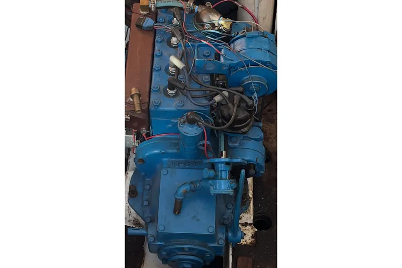 Slide: The Image of 1974 Tartan Sloop engine, blue with visible wiring and components. - 9
