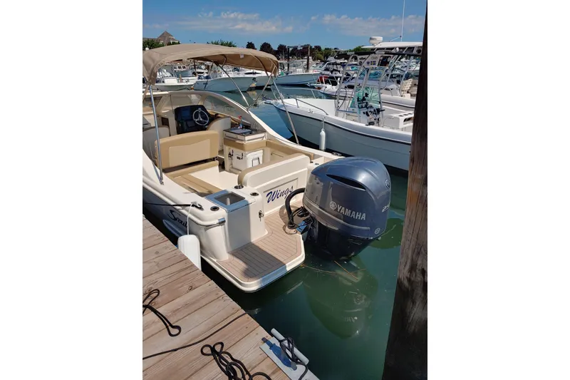 Slide: The Image of 2019 Scout 235 Dorado boat docked with Yamaha outboard motor. - 3