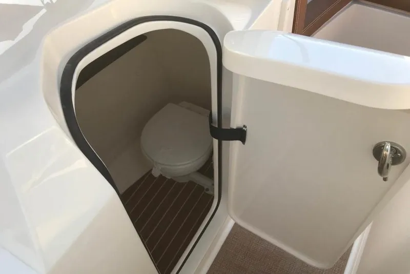Slide: The Image of Manufacturer Provided Image: 2019 Scout 235 Dorado boat with an open compartment showing a toilet. - 6