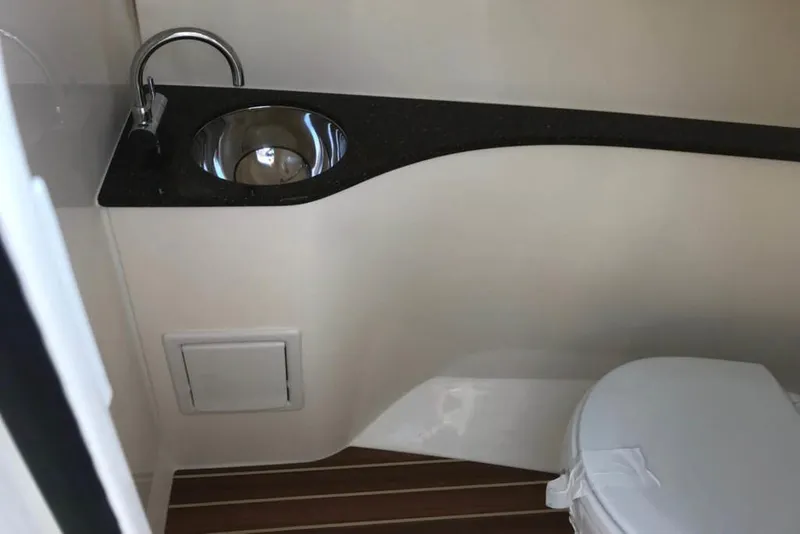 Slide: The Image of Manufacturer Provided Image: 2019 Scout 235 Dorado boat bathroom with sink and toilet. - 7