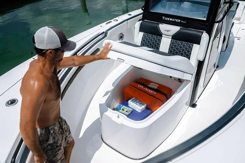 Slide: The Image of 2023 Tidewater 282 CC Adventure Bluewater boat interior with cushioned seating and speakers. - 12
