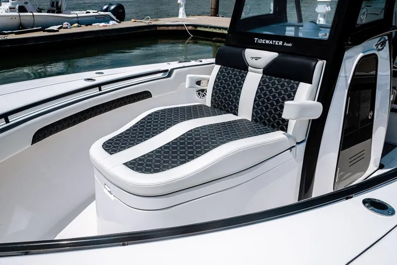 Slide: The Image of 2023 Tidewater 282 CC Adventure Bluewater boat dashboard with dual screens and controls. - 13