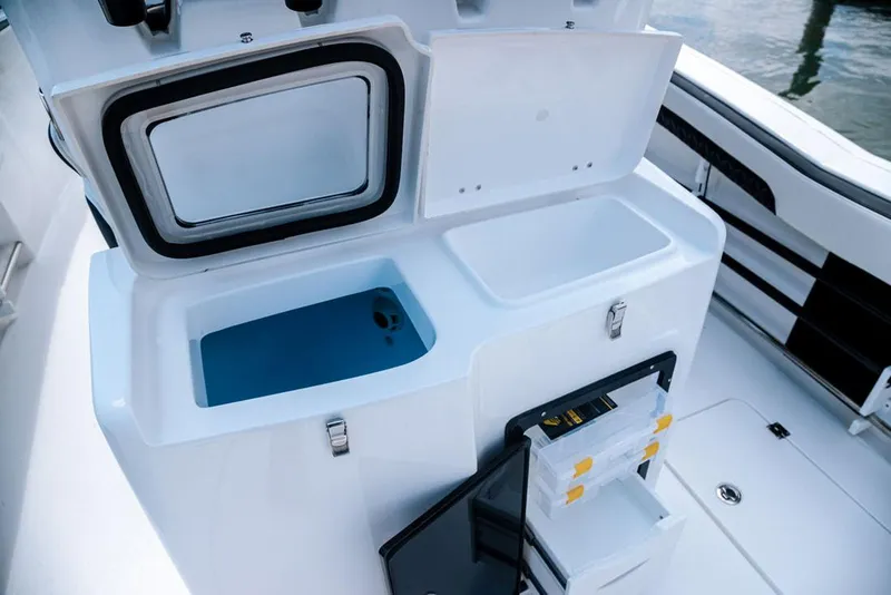 Slide: The Image of 2023 Tidewater 282 CC Adventure Bluewater boat cockpit with dual seats and steering wheel. - 16