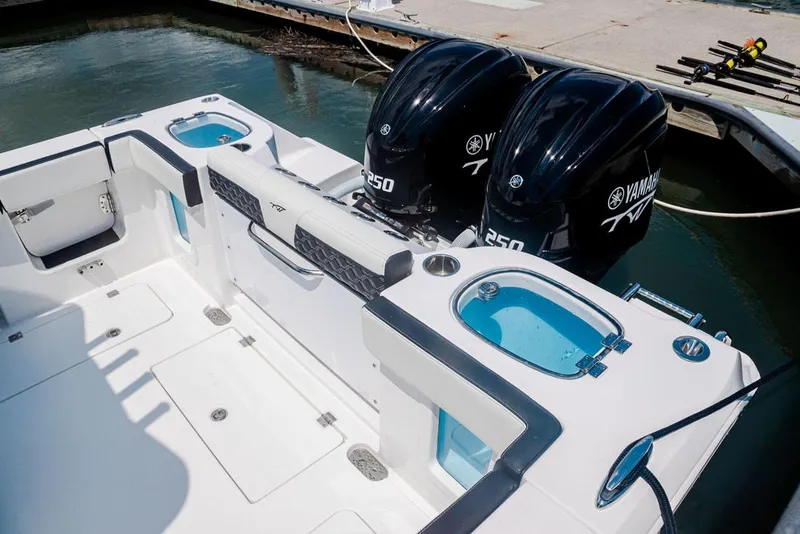 Slide: The Image of 2023 Tidewater 282 CC Adventure Bluewater boat interior with seating and dual engines. - 18