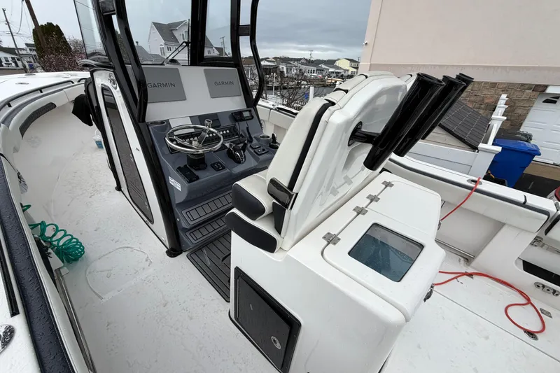 Slide: The Image of 2023 Tidewater 282 CC Adventure Bluewater boat interior with Garmin navigation system. - 21