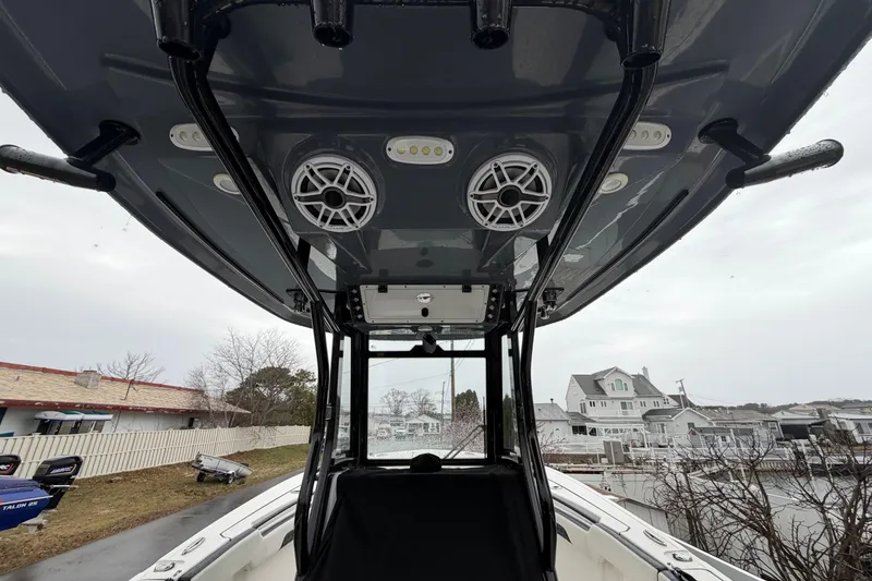 Slide: The Image of 2023 Tidewater 282 CC Adventure Bluewater boat interior with speakers and canopy. - 24
