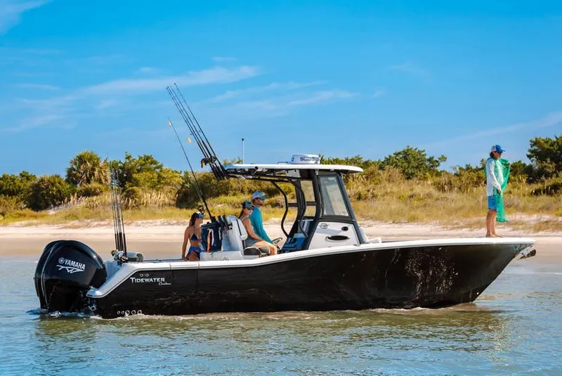 Slide: The Image of 2023 Tidewater 282 CC Adventure Bluewater cruising on open sea under clear blue sky. - 6