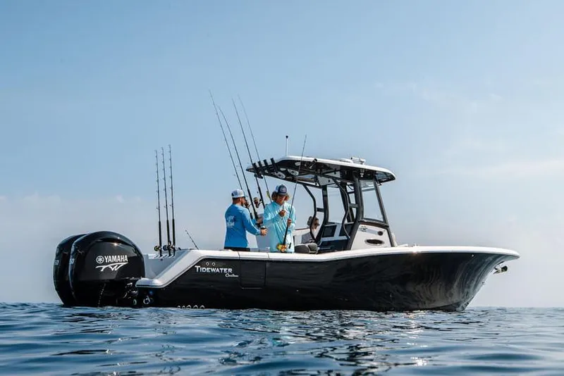 Slide: The Image of 2023 Tidewater 282 CC Adventure Bluewater boat docked near waterfront homes. - 8