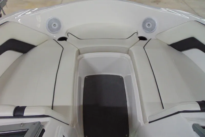 Slide: The Image of 2016 Yamaha Boats AR190 interior seating with speakers, featuring white and black upholstery. - 10