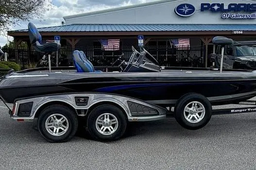 The Image of 2023 Ranger Z520R boat parked outside dealership with American flags. - 0