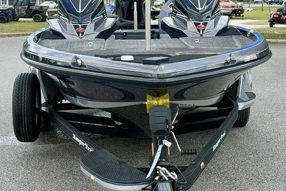 Slide: The Image of 2023 Ranger Z520R boat on trailer, sleek design, dual motors, parked outdoors. - 2