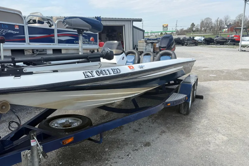 Slide: The Image of 2003 Champion 187 CX boat on trailer in outdoor storage area. - 3