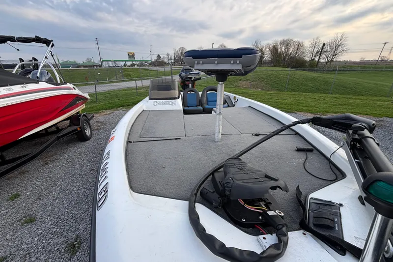 Slide: The Image of 2003 Champion 187 CX boat with fishing seat and equipment on deck. - 6