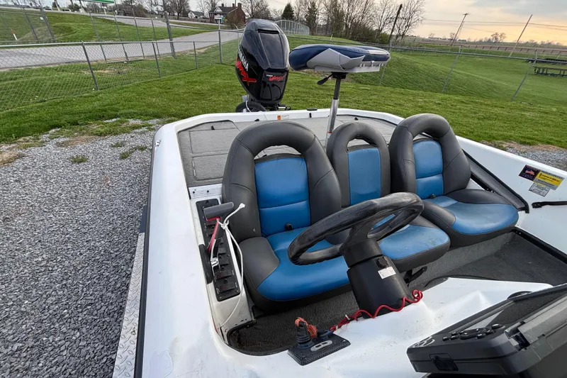 Slide: The Image of 2003 Champion 187 CX boat interior with blue seats and steering wheel. - 7
