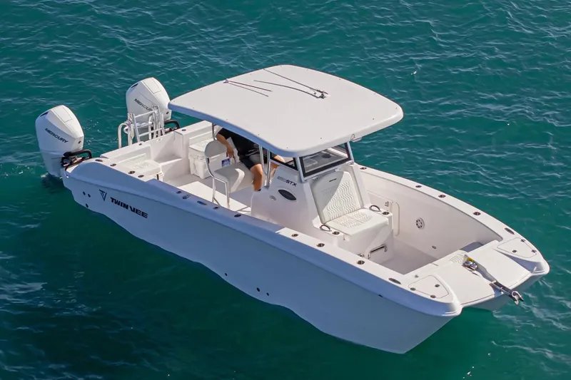 The Image of Manufacturer Provided Image: 2026 Twin Vee 260 STX CC boat cruising on clear blue water. - 0