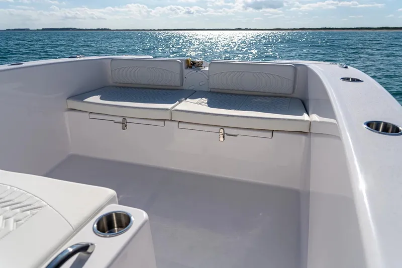 Slide: The Image of Manufacturer Provided Image: 2026 Twin Vee 260 STX CC boat interior with cushioned seating and ocean view. - 13