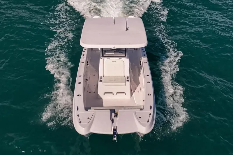 Slide: The Image of Manufacturer Provided Image: 2026 Twin Vee 260 STX CC boat cruising on open water, aerial view. - 3