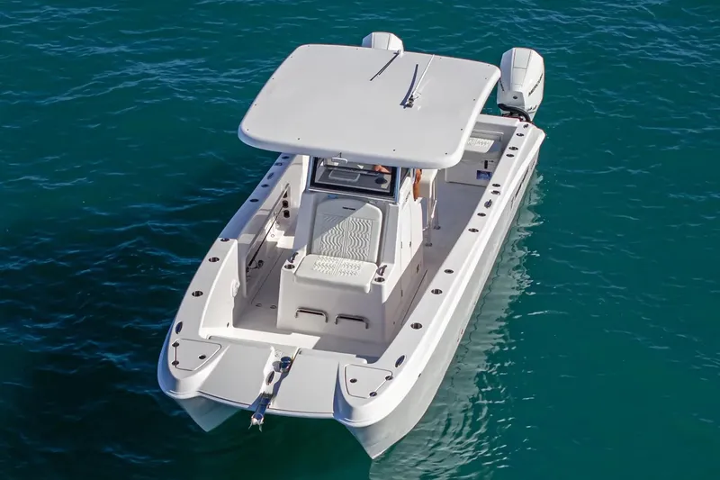 Slide: The Image of Manufacturer Provided Image: 2026 Twin Vee 260 STX CC boat on clear blue water, aerial view. - 4