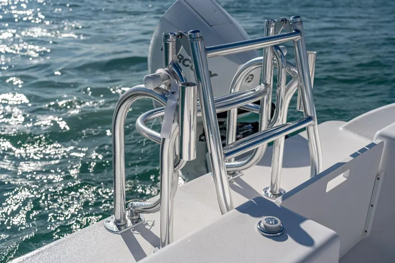 Slide: The Image of Twin Vee 260 STX CC 2026 boat with stainless steel ladder on water. - 7