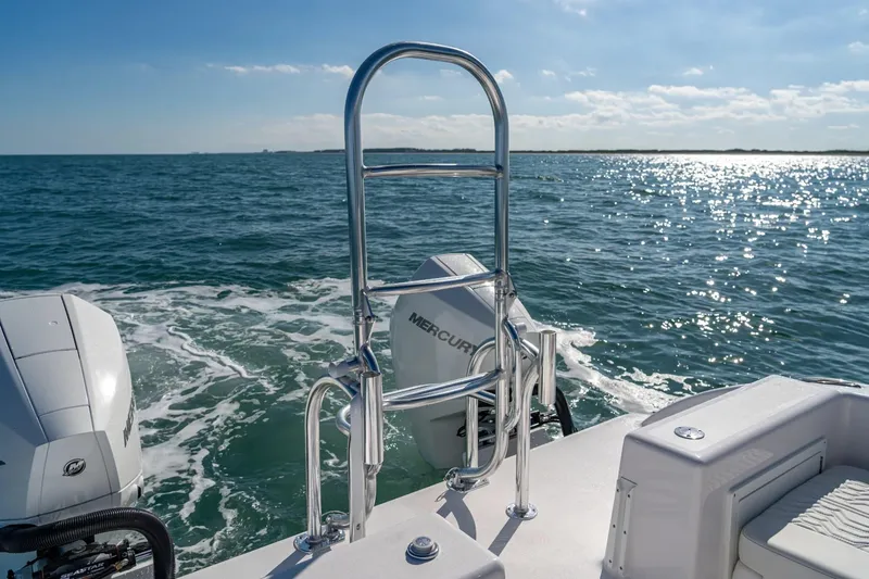 Slide: The Image of Twin Vee 260 STX CC 2026 on open sea with Mercury engines. - 8