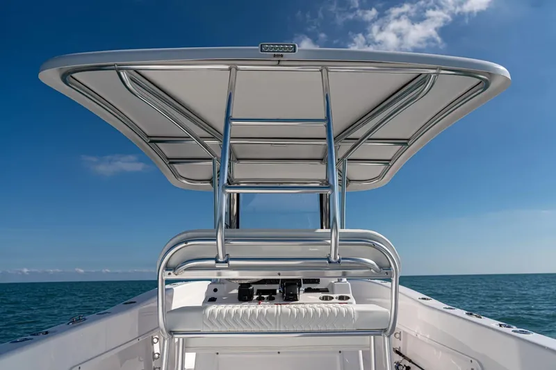 Slide: The Image of Twin Vee 260 STX CC 2026 boat with T-top on open sea. - 9