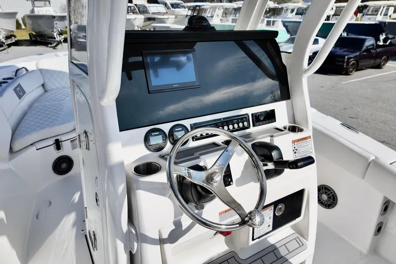 Slide: The Image of 2026 Sea Fox 228 Commander boat dashboard with steering wheel and navigation controls. - 11