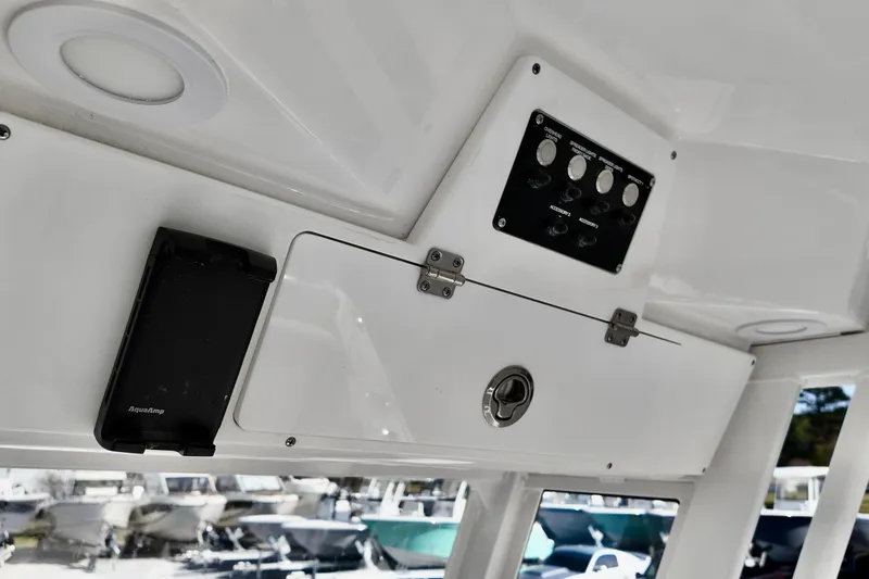 Slide: The Image of Interior view of 2026 Sea Fox 228 Commander boat's control panel and storage compartment. - 12
