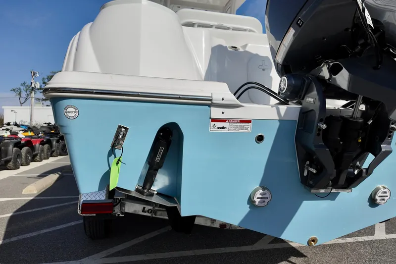 Slide: The Image of 2026 Sea Fox 228 Commander boat rear view with outboard motor in parking lot. - 4