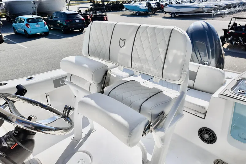 Slide: The Image of 2026 Sea Fox 228 Commander boat interior with white cushioned seating and steering wheel. - 7