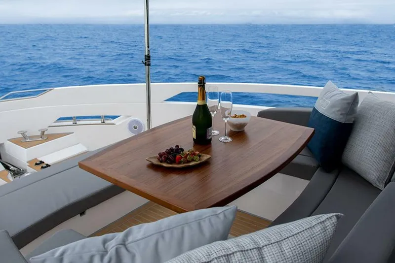 Slide: The Image of Luxury OKEAN 52 yacht interior with champagne, fruit, and ocean view, 2025 model. - 10