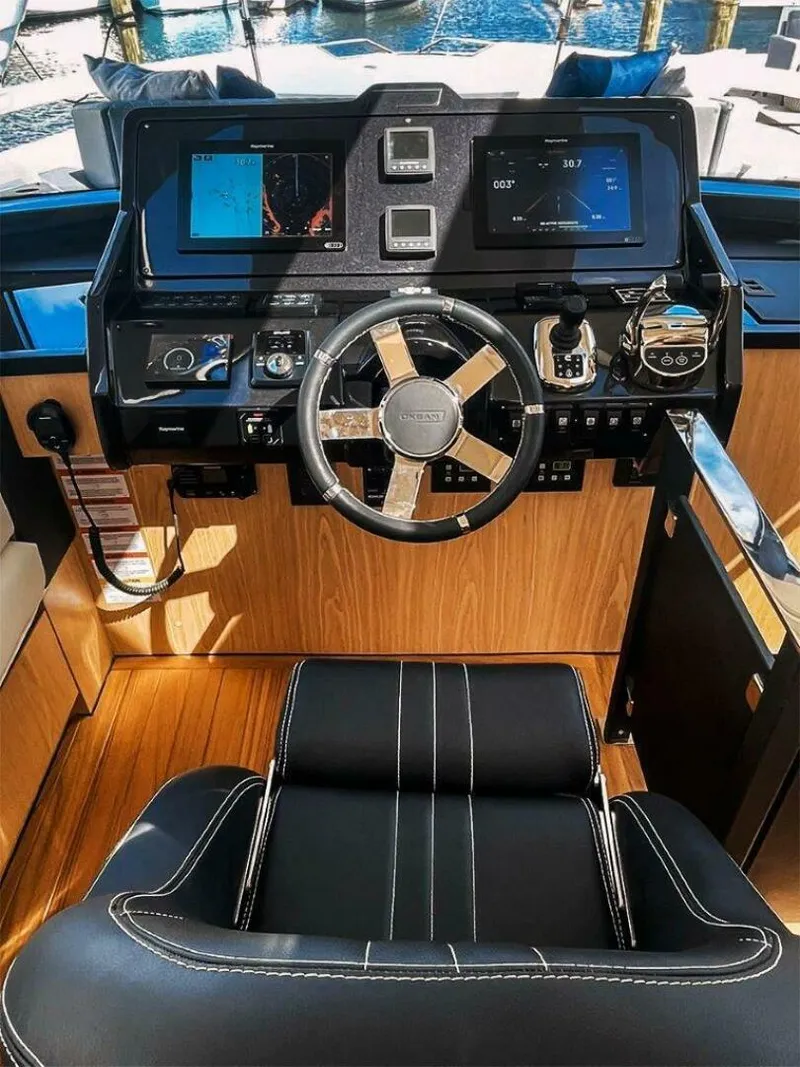 Slide: The Image of Helm of 2025 OKEAN 52 yacht with modern controls and navigation screens. - 17