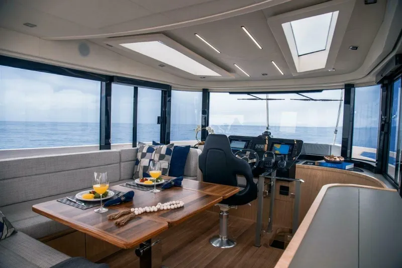 Slide: The Image of Luxurious interior of 2025 OKEAN 52 yacht with ocean view and elegant dining setup. - 29