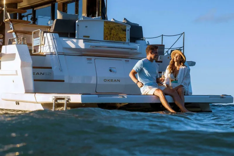 Slide: The Image of Couple relaxing on OKEAN 52 yacht, 2025 model, enjoying the ocean view. - 37
