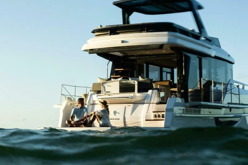 Slide: The Image of Couple relaxing on 2025 OKEAN 52 yacht, enjoying the ocean view. - 43