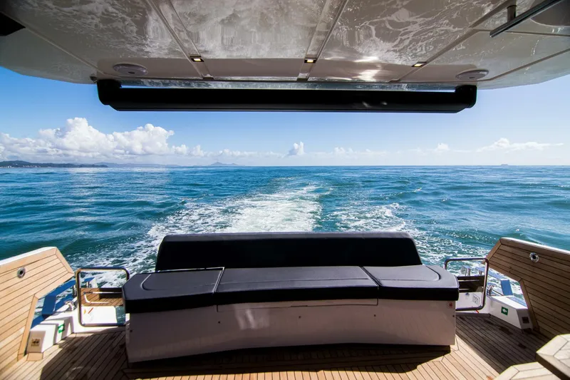 Slide: The Image of Luxury OKEAN 52 yacht deck with ocean view, 2025 model, featuring sleek seating and open sea. - 6