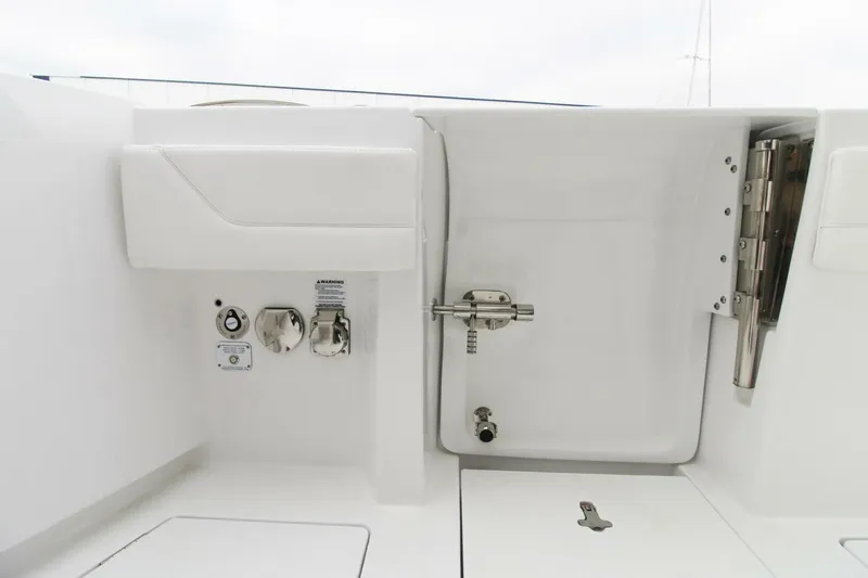 Slide: The Image of 2024 Intrepid 375 Nomad SE boat deck with utility access and storage features. - 22