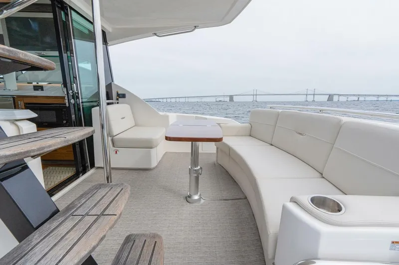 Slide: The Image of 2021 Tiara Yachts F44 Flybridge with elegant seating and ocean view. - 13