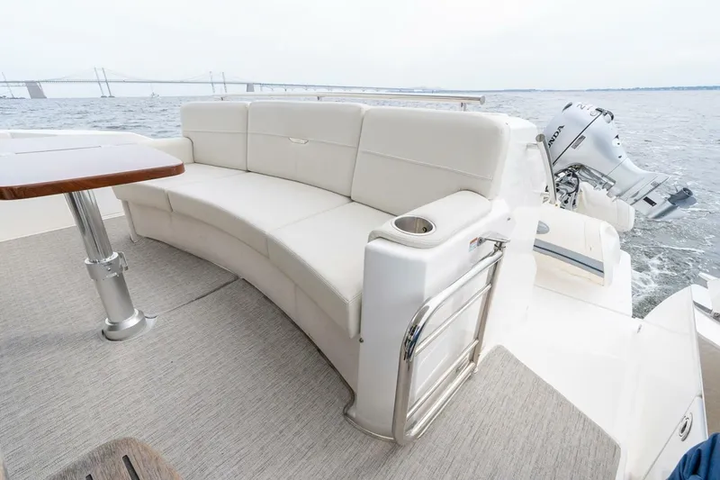 Slide: The Image of Luxurious seating area on 2021 Tiara Yachts F44 Flybridge with scenic ocean view. - 14