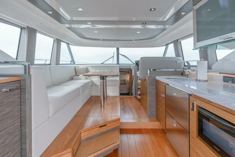 Slide: The Image of Luxurious interior of 2021 Tiara Yachts F44 Flybridge with modern kitchen and seating area. - 18