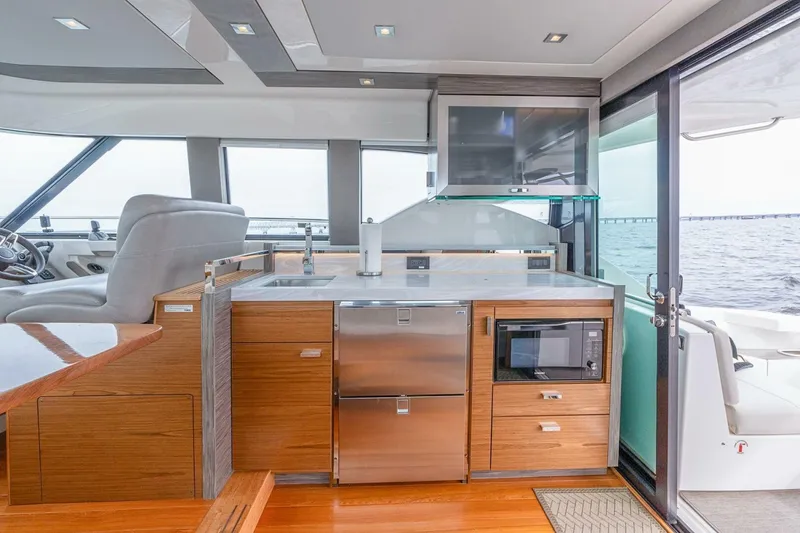 Slide: The Image of Luxurious 2021 Tiara Yachts F44 Flybridge interior with modern kitchen and ocean view. - 19