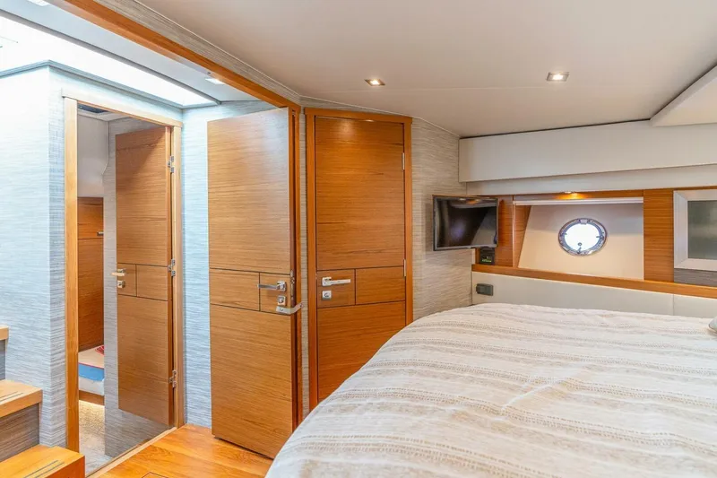 Slide: The Image of Luxurious 2021 Tiara Yachts F44 Flybridge cabin interior with wood accents and porthole window. - 29