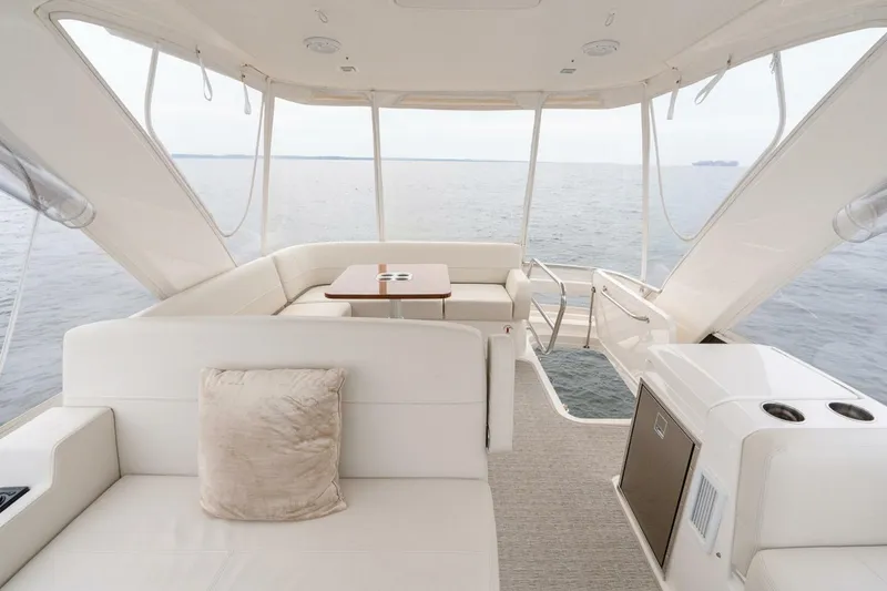 Slide: The Image of Luxurious 2021 Tiara Yachts F44 Flybridge interior with ocean view, featuring elegant seating. - 51