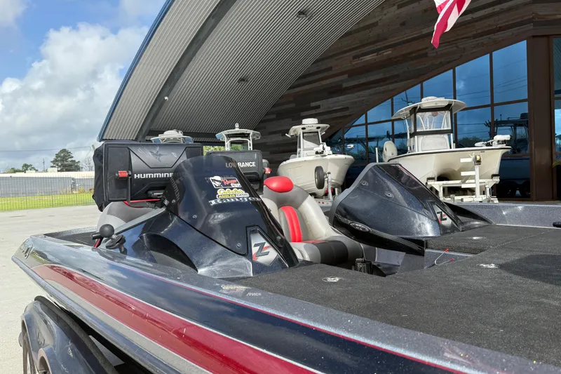 Slide: The Image of 2011 Ranger 521SVX Comanche boat with advanced navigation equipment, parked near a modern building. - 10