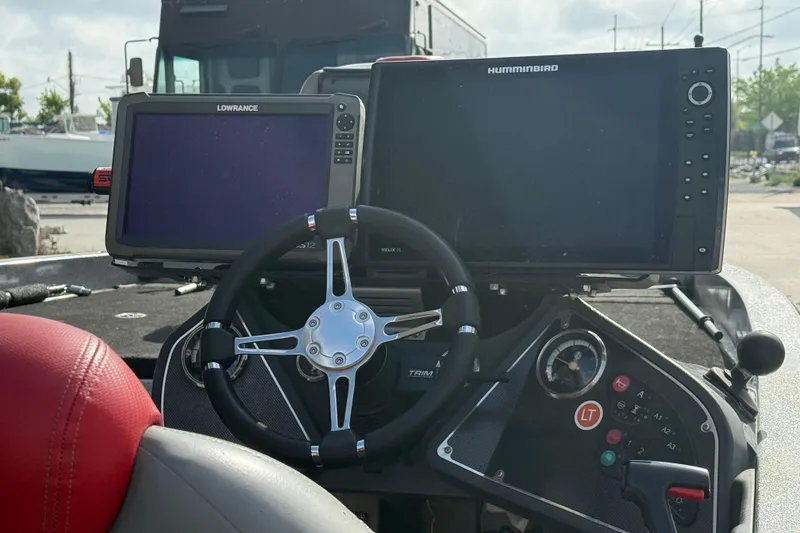 Slide: The Image of Dashboard of a 2011 Ranger 521SVX Comanche boat with navigation screens. - 11