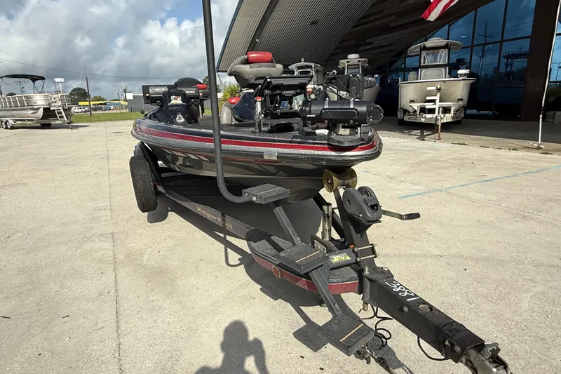 Slide: The Image of 2011 Ranger 521SVX Comanche boat on trailer, parked outdoors near a building. - 13