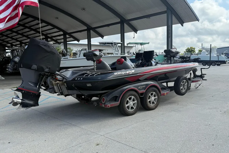 Slide: The Image of 2011 Ranger 521SVX Comanche boat on trailer under covered dock. - 3
