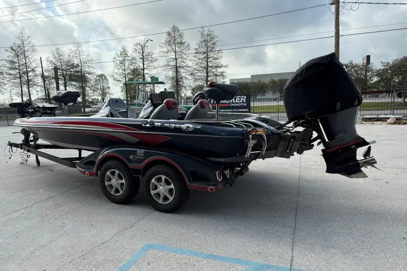 Slide: The Image of 2011 Ranger 521SVX Comanche boat with dual axle trailer, parked outdoors. - 5