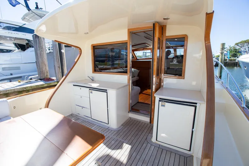 Slide: The Image of 2017 Palm Beach PB42 yacht interior with sleek cabinetry and seating area. - 13