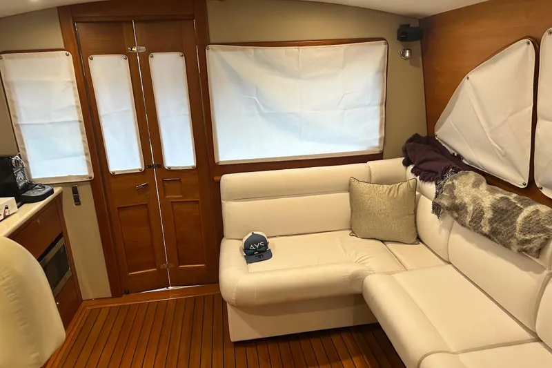 Slide: The Image of Interior of 2017 Palm Beach PB42 yacht with white seating and wooden flooring. - 21